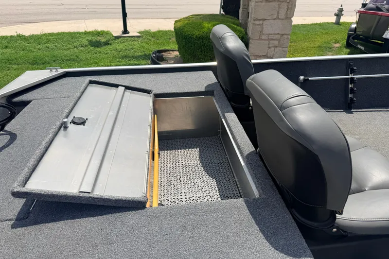 Slide: The Image of 2019 Bass Tracker III Classic boat interior with open storage compartment and seating. - 24