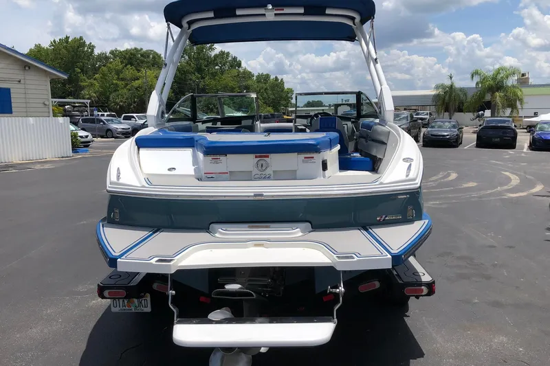 Slide: The Image of 2021 Cobalt CS22 boat with blue and white seating, parked outdoors. - 10