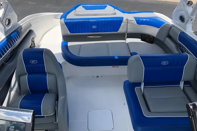 Slide: The Image of 2021 Cobalt CS22 boat interior with blue and gray seating, showcasing modern design. - 20