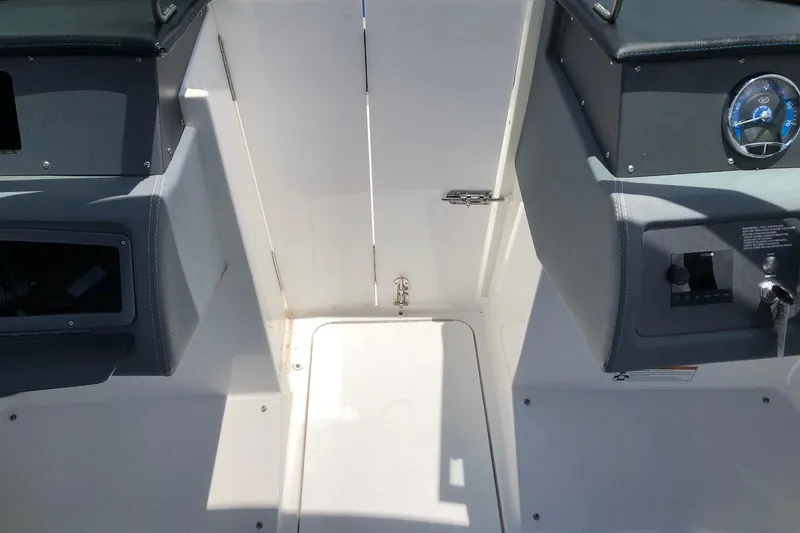 Slide: The Image of Interior view of a 2021 Cobalt CS22 boat cockpit with steering and control panels. - 22