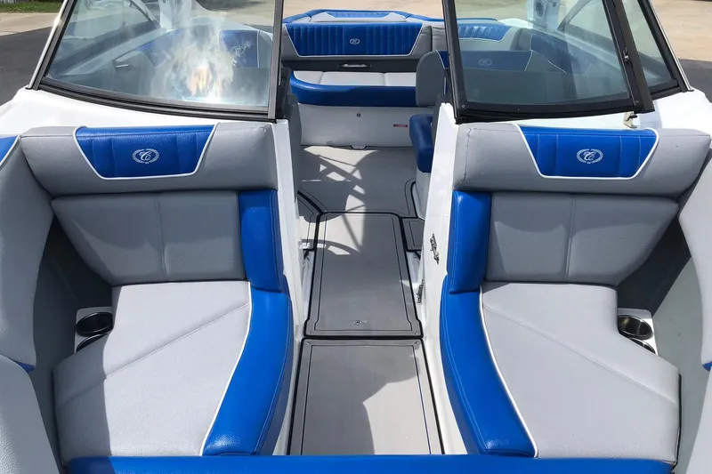 Slide: The Image of 2021 Cobalt CS22 boat interior with blue and gray seating, showcasing modern design. - 23