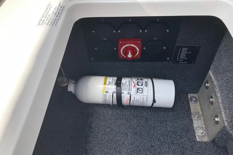 Slide: The Image of Fire extinguisher and control panel in 2021 Cobalt CS22 boat compartment. - 25