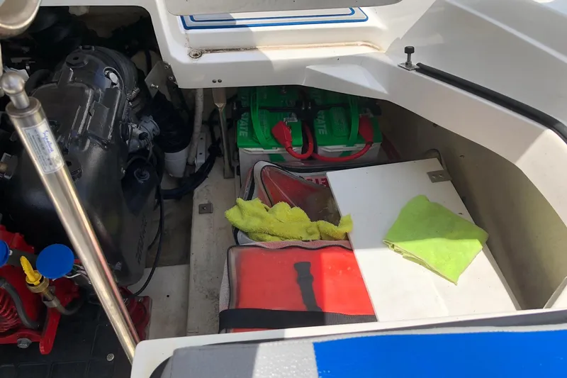 Slide: The Image of Engine compartment of a 2021 Cobalt CS22 boat with maintenance tools and supplies. - 26