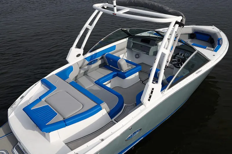 Slide: The Image of Manufacturer Provided Image: 2021 Cobalt CS22 boat with blue and white interior on water. - 29