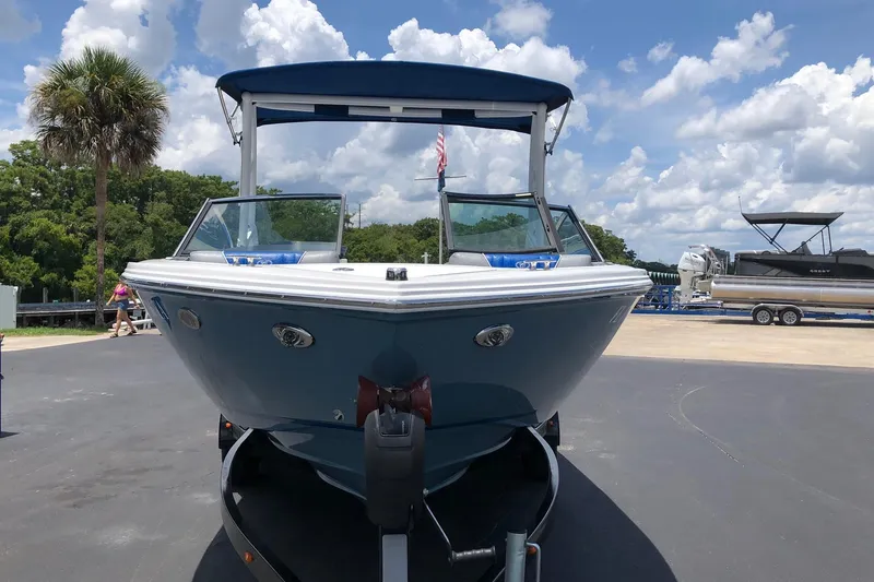 Slide: The Image of 2021 Cobalt CS22 boat on trailer under blue sky with clouds. - 3