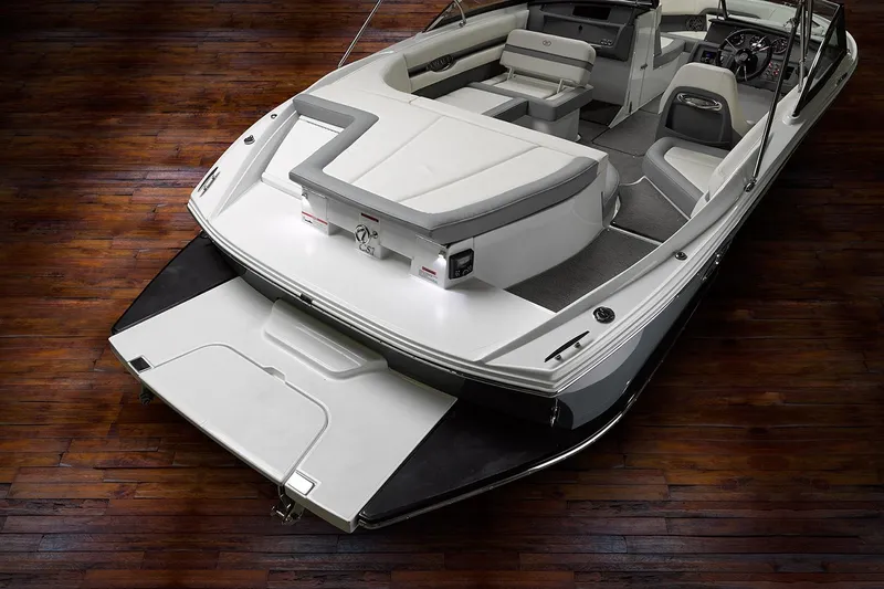 Slide: The Image of Manufacturer Provided Image: 2021 Cobalt CS22 boat interior with white and gray seating on wooden floor. - 30