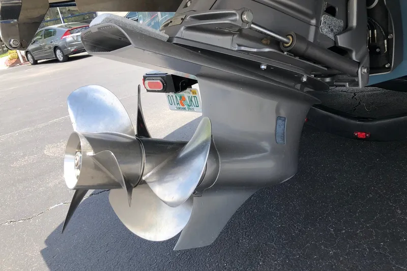 Slide: The Image of Close-up of a 2021 Cobalt CS22 boat propeller and outdrive on pavement. - 7
