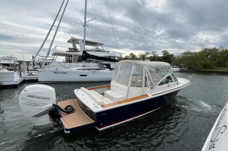 Slide: The Image of 2018 Hunt Yachts Harrier 25 in marina, featuring Mercury outboard engine. - 12