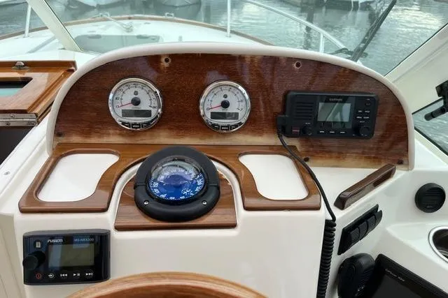 Slide: The Image of Dashboard of 2018 Hunt Yachts Harrier 25 with compass, gauges, and navigation equipment. - 16