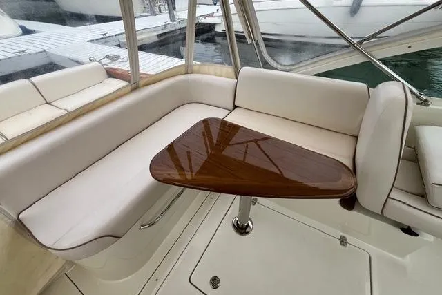 Slide: The Image of 2018 Hunt Yachts Harrier 25 interior with elegant seating and polished wooden table. - 18