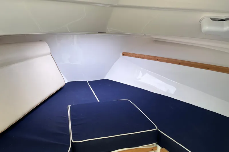 Slide: The Image of 2018 Hunt Yachts Harrier 25 cabin interior with blue and white cushions. - 21
