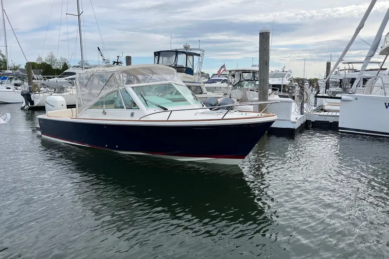 Slide: The Image of 2018 Hunt Yachts Harrier 25 docked in a marina, featuring a sleek design and clear canopy. - 4