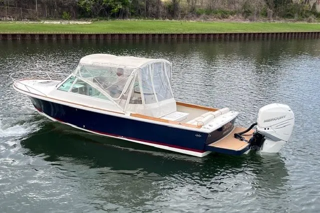 Slide: The Image of 2018 Hunt Yachts Harrier 25 boat with canopy cruising on a calm waterway. - 5