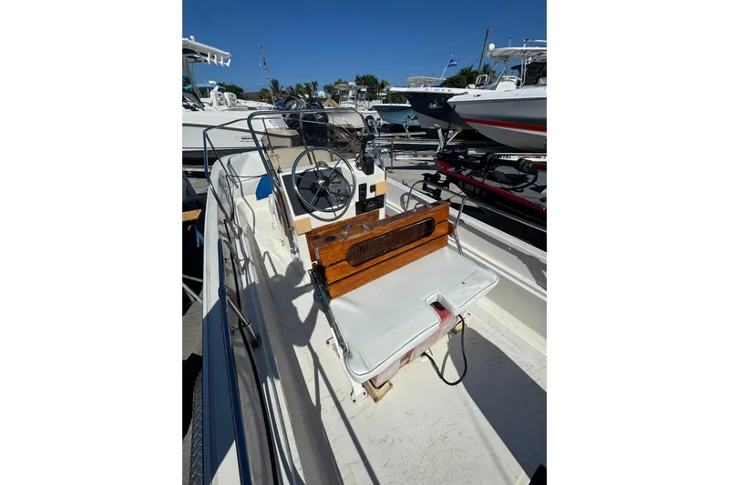 Slide: The Image of 1988 Boston Whaler 170 Montauk boat interior with steering wheel and seating. - 10