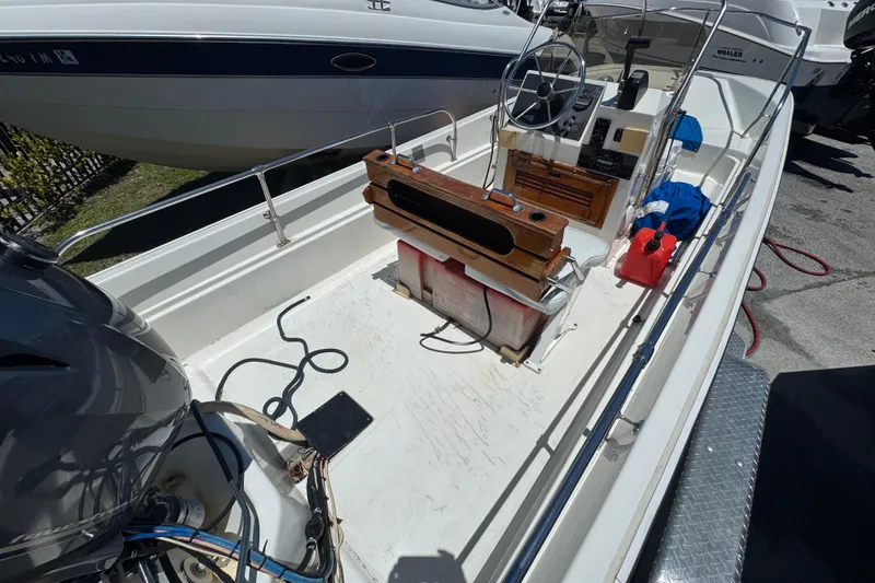 Slide: The Image of 1988 Boston Whaler 170 Montauk boat interior with steering console and equipment. - 2