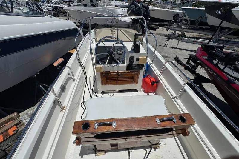 Slide: The Image of 1988 Boston Whaler 170 Montauk boat interior with steering wheel and seating. - 3