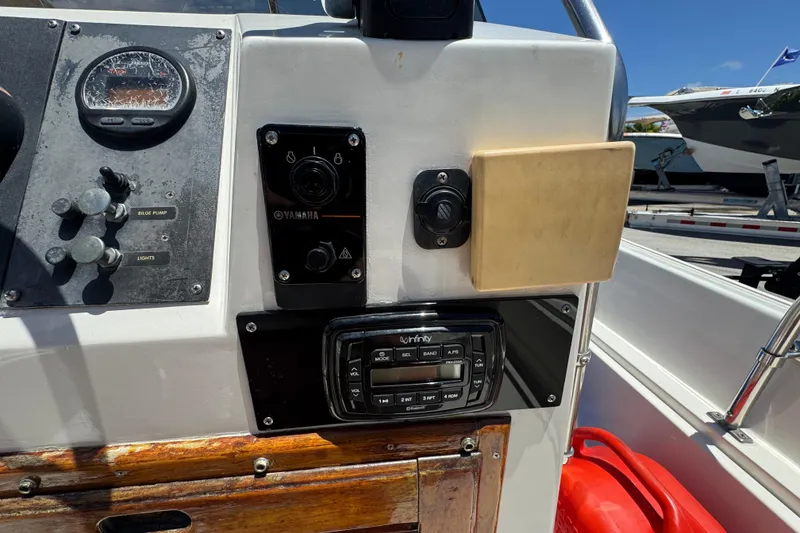 Slide: The Image of 1988 Boston Whaler 170 Montauk dashboard with Yamaha controls and Infinity audio system. - 4