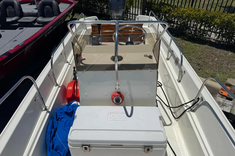 Slide: The Image of 1988 Boston Whaler 170 Montauk boat interior with steering console and cooler. - 6