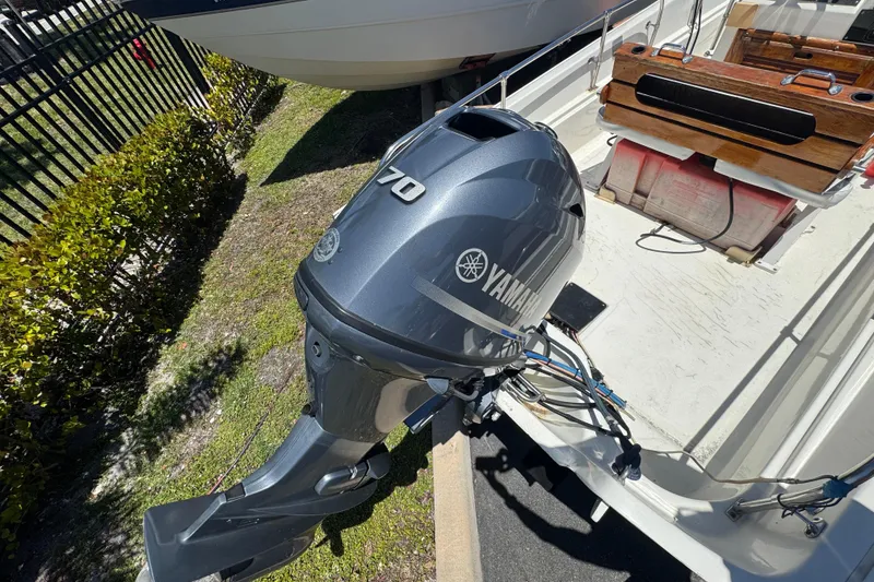 Slide: The Image of 1988 Boston Whaler 170 Montauk with Yamaha outboard motor, docked outdoors. - 7