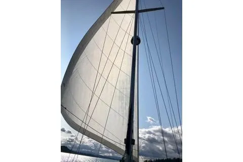 Slide: The Image of Sailing on a 1981 Ta-Shing Panda 40 yacht at sunset, serene waters, vibrant sky. - 1