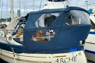 Slide: The Image of 1981 Ta-Shing Panda 40 sailboat with blue canopy docked at marina. - 10