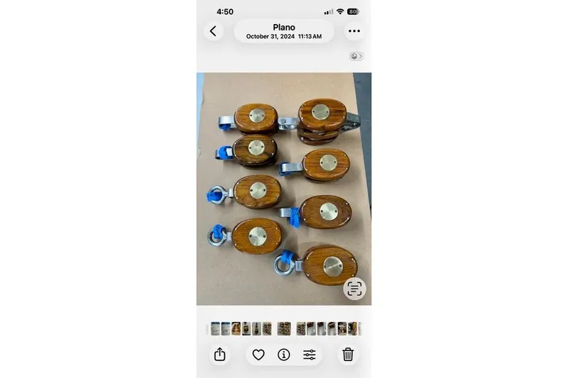 Slide: The Image of Wooden sailing blocks from a 1981 Ta-Shing Panda 40 yacht, displayed on a table. - 13