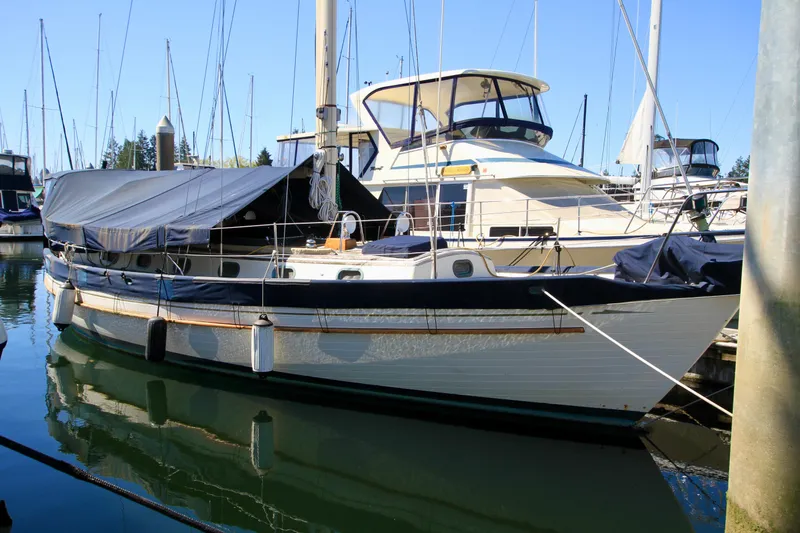 Slide: The Image of 1981 Ta-Shing Panda 40 sailboat docked in a marina, covered with a tarp. - 16