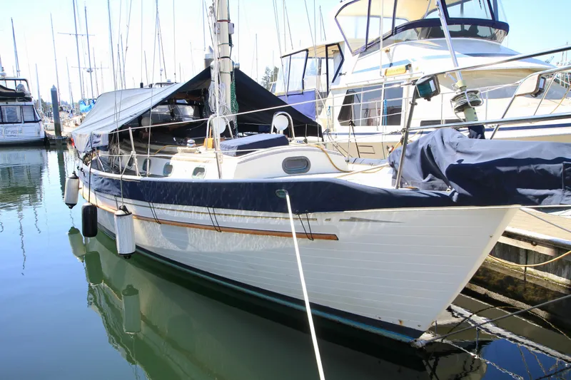 Slide: The Image of 1981 Ta-Shing Panda 40 sailboat docked at marina, featuring classic design and blue accents. - 17