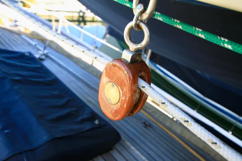 Slide: The Image of Wooden pulley on 1981 Ta-Shing Panda 40 sailboat, with ropes and deck visible. - 22