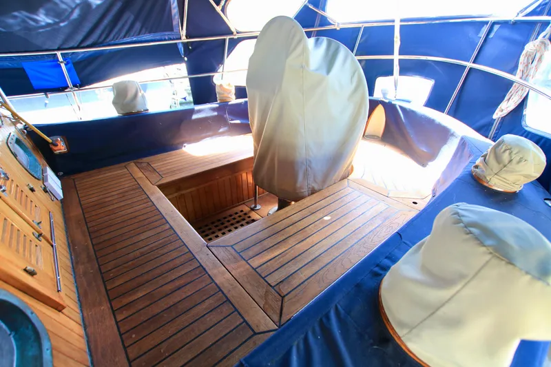 Slide: The Image of 1981 Ta-Shing Panda 40 yacht cockpit with wooden flooring and covered equipment. - 25