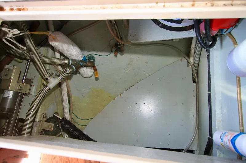 Slide: The Image of Engine compartment of a 1981 Ta-Shing Panda 40 sailboat, showing hoses and mechanical components. - 28