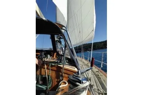 Slide: The Image of 1981 Ta-Shing Panda 40 sailboat with sails up, cruising on a sunny day. - 3