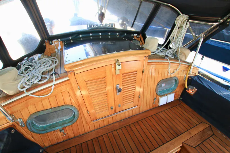 Slide: The Image of Wooden cockpit interior of 1981 Ta-Shing Panda 40 sailboat with ropes and storage. - 30