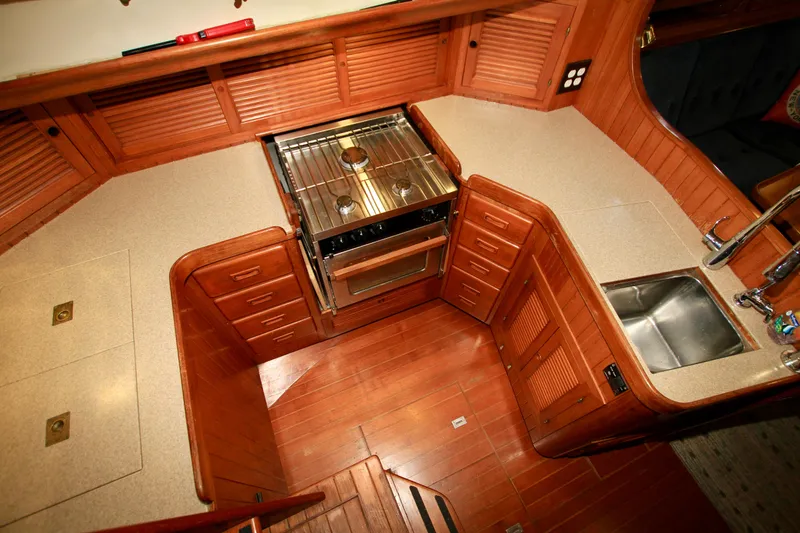 Slide: The Image of 1981 Ta-Shing Panda 40 yacht kitchen with wooden cabinetry, stove, and sink. - 40