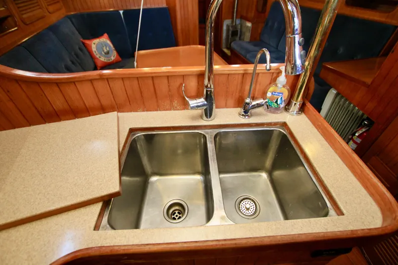 Slide: The Image of Double sink in 1981 Ta-Shing Panda 40 yacht galley with wooden cabinetry. - 41