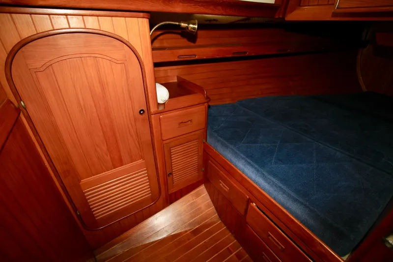 Slide: The Image of Cozy wooden cabin interior of 1981 Ta-Shing Panda 40 sailboat with blue bedding. - 45