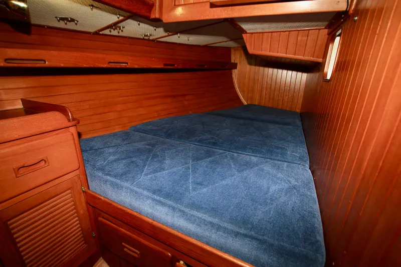 Slide: The Image of Cozy cabin interior of 1981 Ta-Shing Panda 40 sailboat with blue cushions and wooden finish. - 46