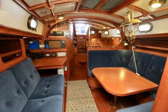 Slide: The Image of Interior of 1981 Ta-Shing Panda 40 sailboat with wooden furnishings and blue seating. - 49