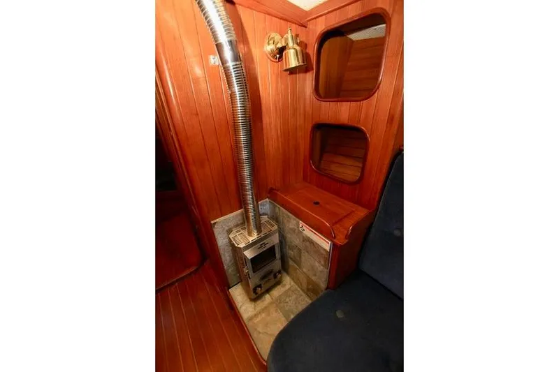 Slide: The Image of Cozy interior of 1981 Ta-Shing Panda 40 sailboat with wood paneling and compact stove. - 59
