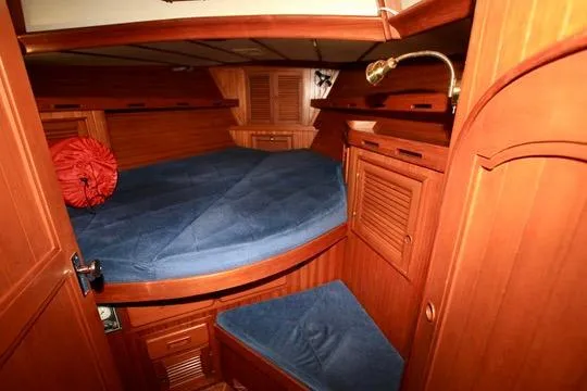Slide: The Image of Cozy wooden cabin interior of 1981 Ta-Shing Panda 40 sailboat with blue bedding. - 62