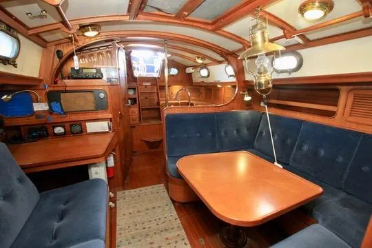Slide: The Image of Interior of 1981 Ta-Shing Panda 40 sailboat with wooden furnishings and blue seating. - 66