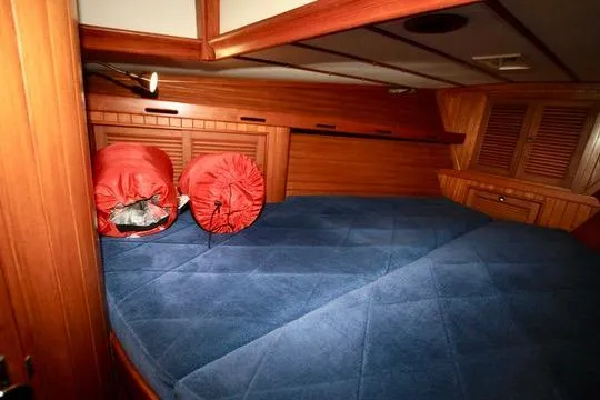 Slide: The Image of Cozy cabin interior of 1981 Ta-Shing Panda 40 sailboat with blue bedding and wooden finish. - 68