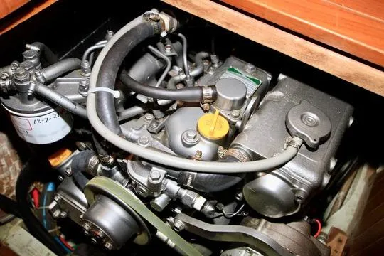 Slide: The Image of Engine of 1981 Ta-Shing Panda 40 sailboat, showcasing mechanical components and hoses. - 70