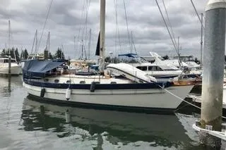 Slide: The Image of 1981 Ta-Shing Panda 40 sailboat docked in a marina with overcast skies. - 8