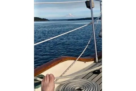 Slide: The Image of Sailing on 1981 Ta-Shing Panda 40 with scenic ocean and mountain view. - 9