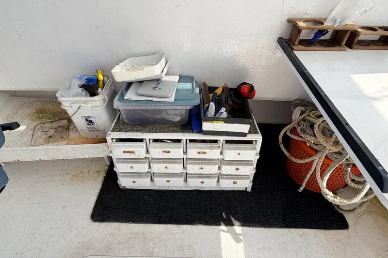 Slide: The Image of Storage area on a 1997 H&H Marine 38 boat with tools and ropes. - 11