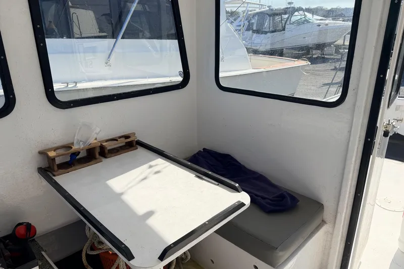 Slide: The Image of Interior of a 1997 H&H Marine 38 boat with table and seating area. - 12