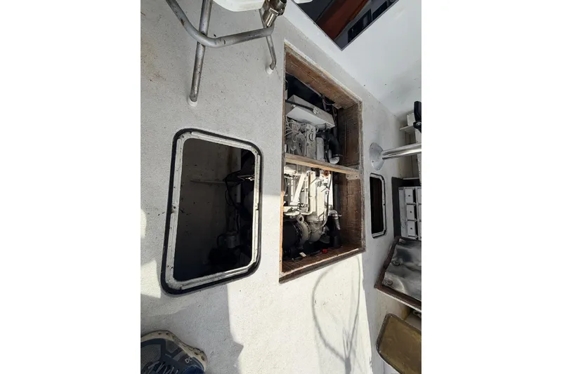 Slide: The Image of Engine compartment of a 1997 H&H Marine 38 boat, showing mechanical components. - 13