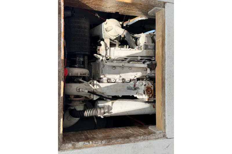 Slide: The Image of Engine compartment of a 1997 H&H Marine 38 boat, showcasing mechanical components. - 18