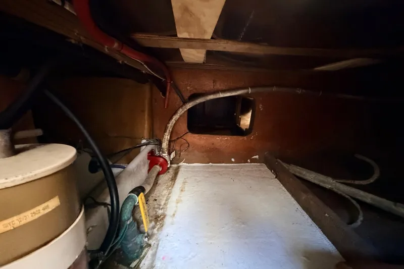 Slide: The Image of Interior view of a 1997 H&H Marine 38 boat showing pipes and equipment. - 19